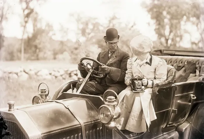 Framed Print : Man Drives Auto While Woman Snaps Photo Framed Print : Man Drives Auto While Woman Snaps Photo