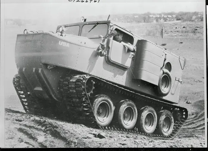 Framed Print : Man Driving a Cargo Carrier Up a Hill