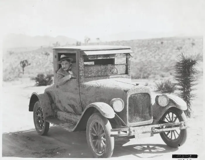 Framed Print : Man Driving Mud-Splattered Car Framed Print : Man Driving Mud-Splattered Car