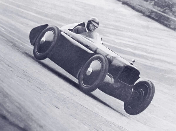 Man driving race car on track (B&W)