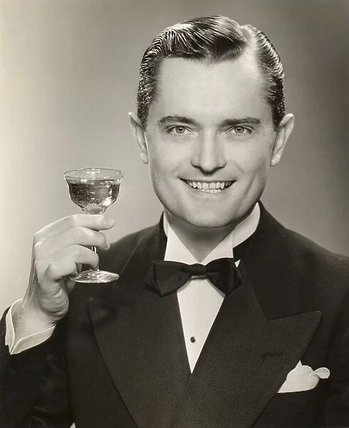 Man in evening clothes raising glass