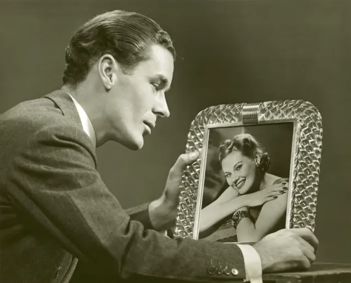 Framed Print : Man gazing at framed photo of woman Framed Print : Man gazing at framed photo of woman