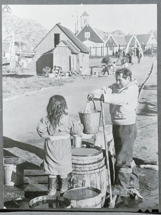 Framed Print : Man Getting Water From a Pipe Framed Print : Man Getting Water From a Pipe
