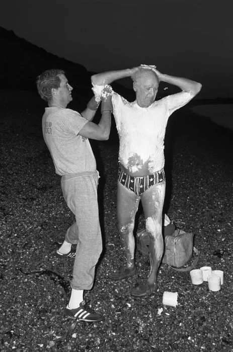 Framed Print : Man Greasing a Swimmer's Body Framed Print : Man Greasing a Swimmer's Body