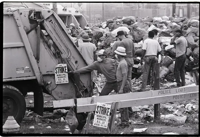 Framed Print : Man Hangs Strike Sign on Garbage Truck Framed Print : Man Hangs Strike Sign on Garbage Truck