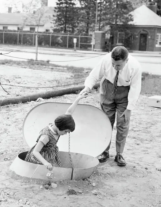 Framed Print : Man Helping Young Girl into Bomb Shelter Framed Print : Man Helping Young Girl into Bomb Shelter