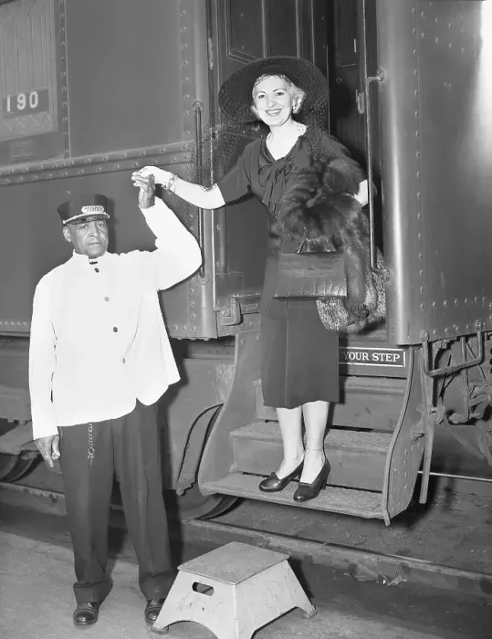 Framed Print : Man Helps Helen Jepson Down from Train Framed Print : Man Helps Helen Jepson Down from Train