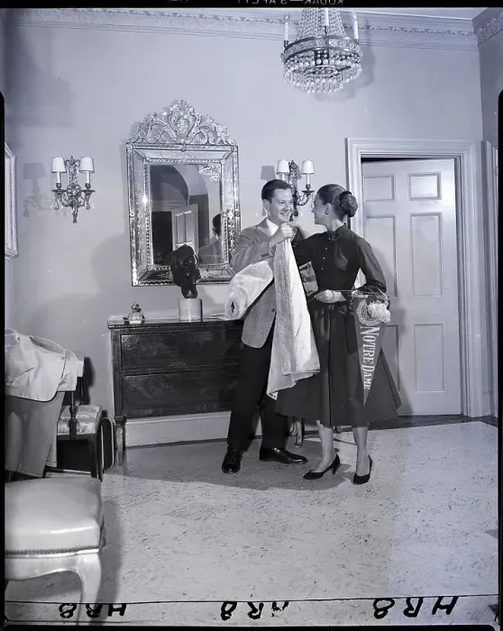 Framed Print : Man Helps Woman On With Coat Framed Print : Man Helps Woman On With Coat