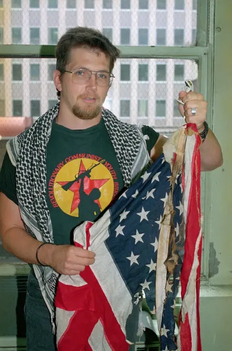 Framed Print : Man Holding Burned American Flag Framed Print : Man Holding Burned American Flag