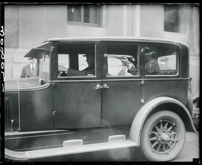 Framed Print : Man Holding Rifle in Police Car Framed Print : Man Holding Rifle in Police Car