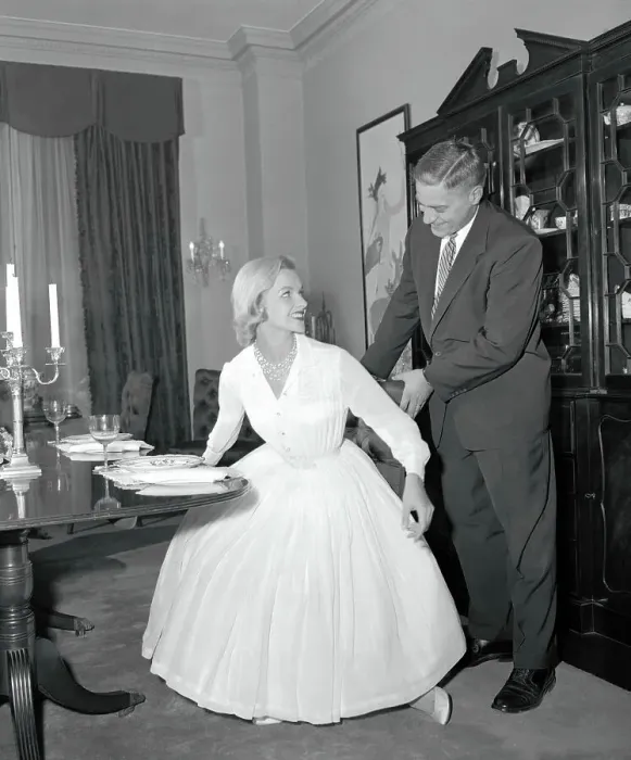 Framed Print : Man Holding a Woman's Chair