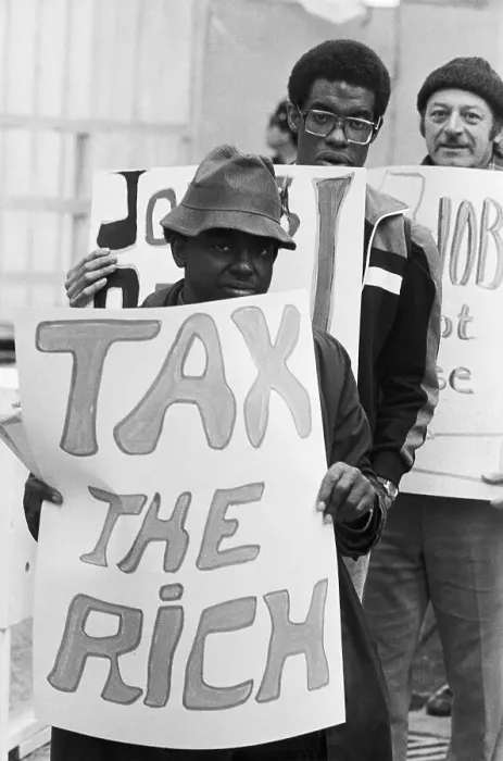 Framed Print : Man Holds Tax The Rich Sign In Protest Framed Print : Man Holds Tax The Rich Sign In Protest