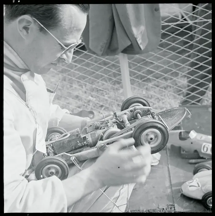 Framed Print : Man Inspecting Miniature Car Framed Print : Man Inspecting Miniature Car