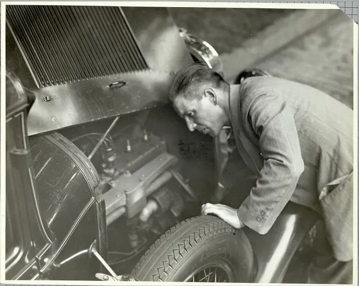 Framed Print : Man Inspecting Motor of Used Automobile Framed Print : Man Inspecting Motor of Used Automobile