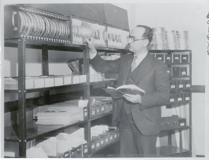 Framed Print : Man Inspecting Reels of Film Framed Print : Man Inspecting Reels of Film