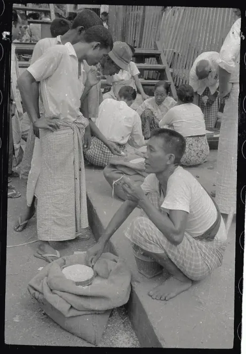 Framed Print : Man Inspecting Rice in Market Framed Print : Man Inspecting Rice in Market