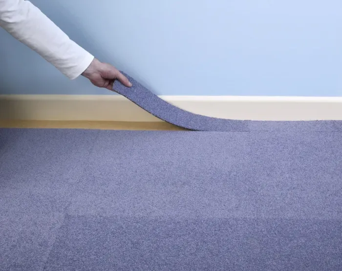 Framed Print : Man installing blue carpet tile next to skirting board Framed Print : Man installing blue carpet tile next to skirting board