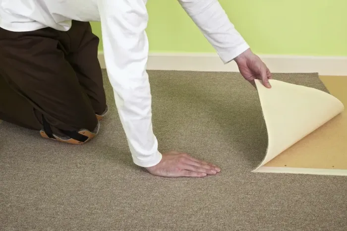 Framed Print : Man installing carpet tiles on top of plywood floor Framed Print : Man installing carpet tiles on top of plywood floor