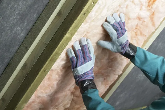Framed Print : Man installing roof insulation in rafter, close-up Framed Print : Man installing roof insulation in rafter, close-up