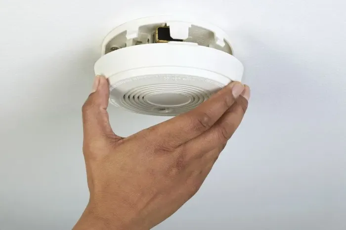 Framed Print : Man installing smoke detector, close-up Framed Print : Man installing smoke detector, close-up