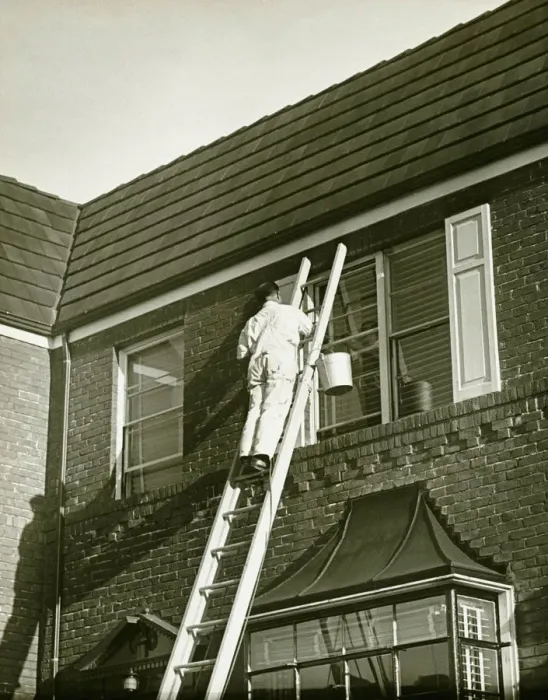 Framed Print : Man on ladder painting shutter (Rear view), (B&W), low angle view