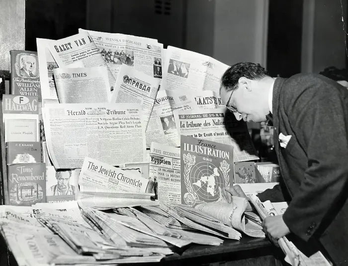 Framed Print : Man Leafs Through International News Framed Print : Man Leafs Through International News