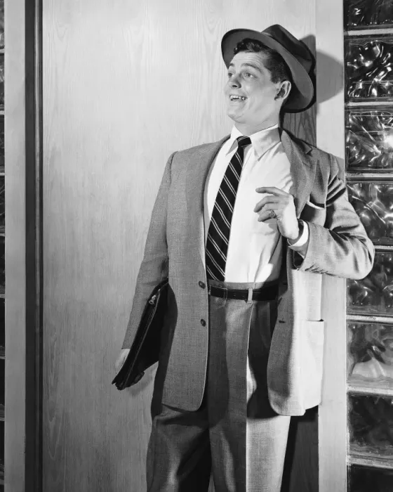 Framed Print : Man leaning against door, smiling Framed Print : Man leaning against door, smiling