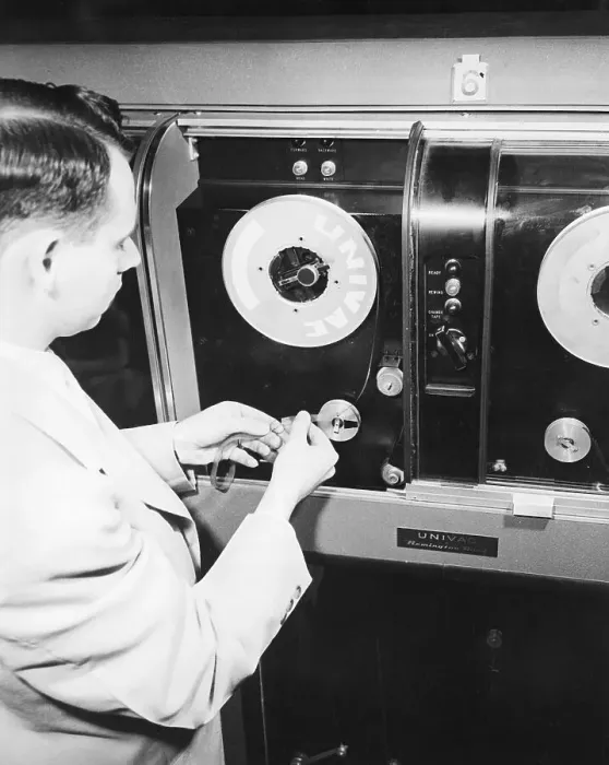 Framed Print : Man Loading Tape Into Early Computer Framed Print : Man Loading Tape Into Early Computer