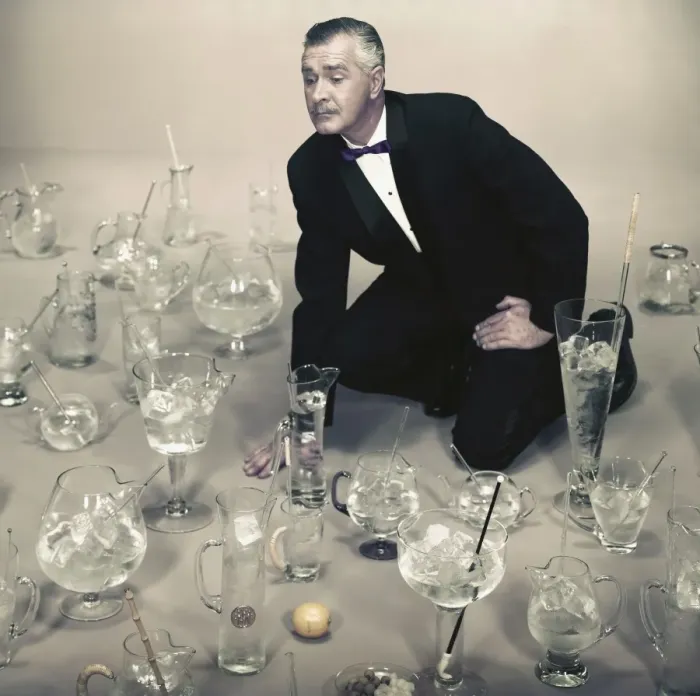 Framed Print : Man looking at different types of glasses filled with ice cubes