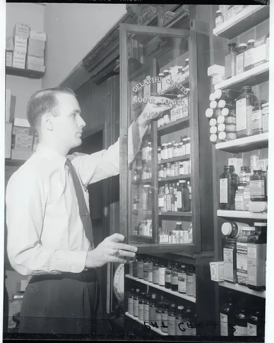 Framed Print : Man Looking Through Drug Cabinet Framed Print : Man Looking Through Drug Cabinet