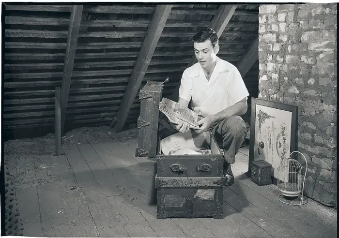 Framed Print : Man Looking at Papers in a Trunk Framed Print : Man Looking at Papers in a Trunk
