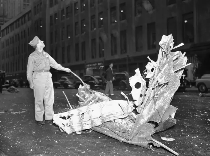 Framed Print : Man Looking at Plane Crash Debris Framed Print : Man Looking at Plane Crash Debris