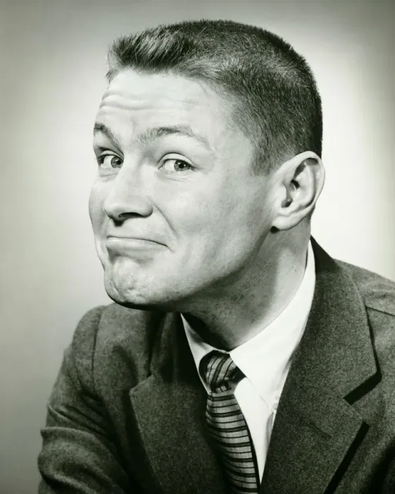 Framed Print : Man making face in studio, (B&W), close-up Framed Print : Man making face in studio, (B&W), close-up