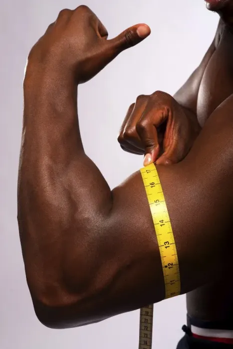 Framed Print : Man measuring his biceps with a tape measure Framed Print : Man measuring his biceps with a tape measure
