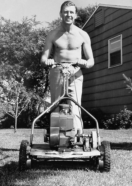 MAN MOWING HIS LAWN, 1950S