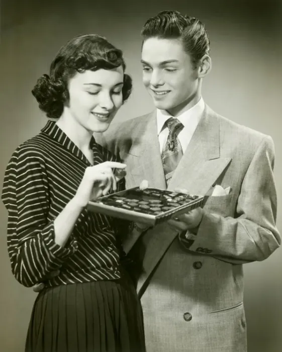 Framed Print : Man offering woman box of chocolates Framed Print : Man offering woman box of chocolates