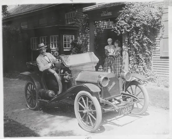 Framed Print : Man in Old-Fashioned Car