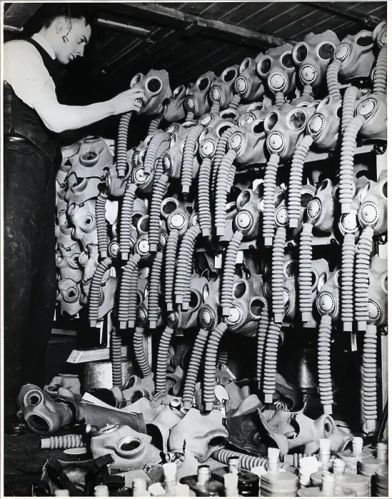 Framed Print : Man Places Mask Atop A Lot Of Gas Masks Framed Print : Man Places Mask Atop A Lot Of Gas Masks