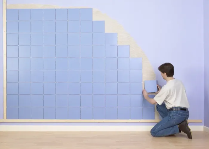 Framed Print : Man placing tile on wall Framed Print : Man placing tile on wall