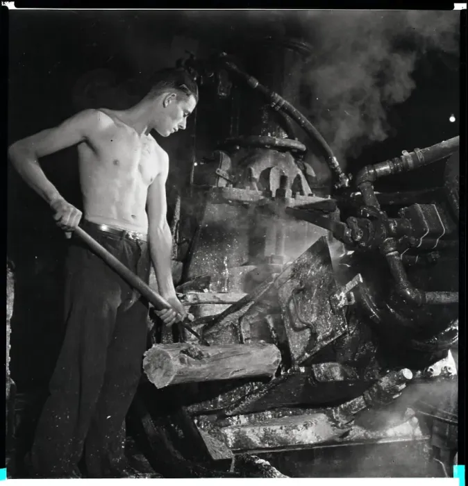 Framed Print : Man Placing Wood Into Machine Framed Print : Man Placing Wood Into Machine