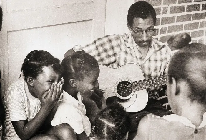 Framed Print : Man Plays Guitar for Laughing Girls Framed Print : Man Plays Guitar for Laughing Girls