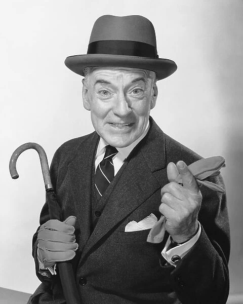 Man pointing, holding umbrella and glove