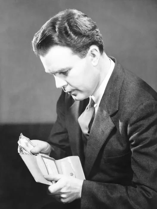 Framed Print : Man putting US dollars bills into wallet, (B&W) Framed Print : Man putting US dollars bills into wallet, (B&W)