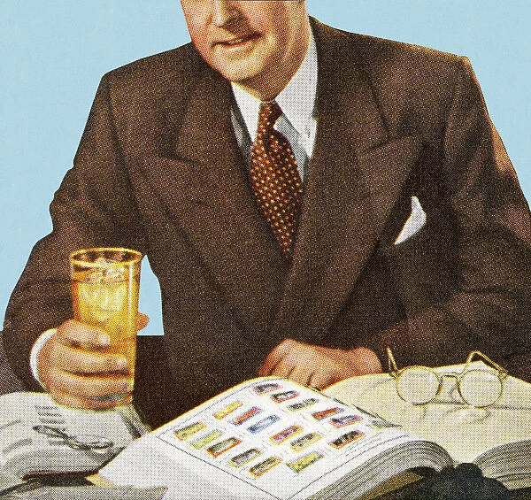 Man Reading And Holding a Drink
