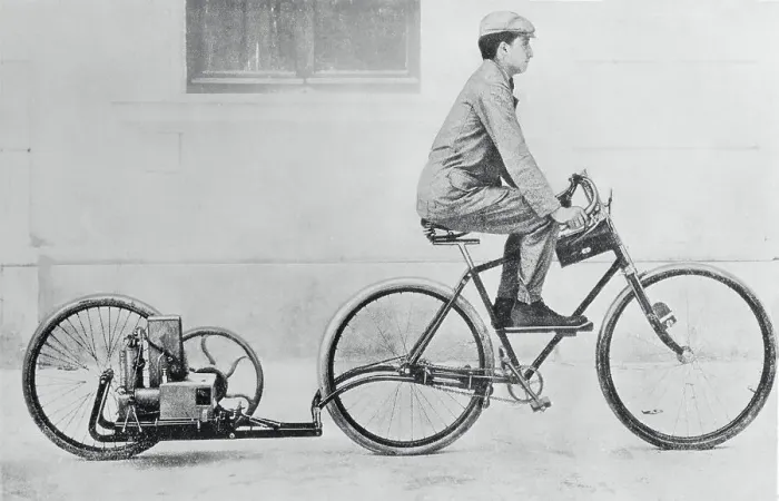 Framed Print : Man Riding Bicycle Being Propelled by Engine Framed Print : Man Riding Bicycle Being Propelled by Engine