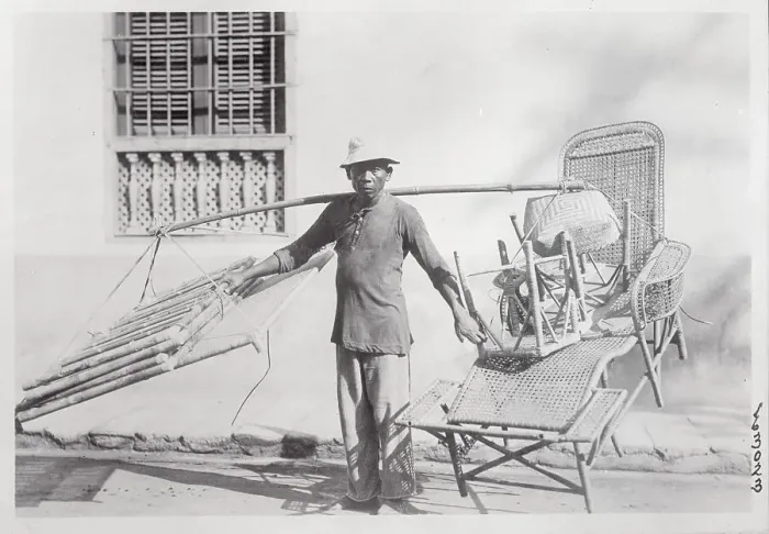 Framed Print : Man Saddled with Wicker Furniture Framed Print : Man Saddled with Wicker Furniture