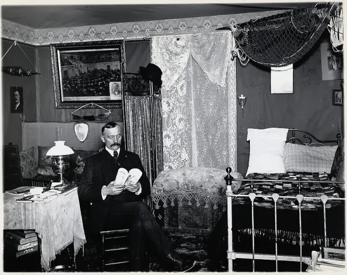 Framed Print : Man Seated in Bedroom Reading Framed Print : Man Seated in Bedroom Reading