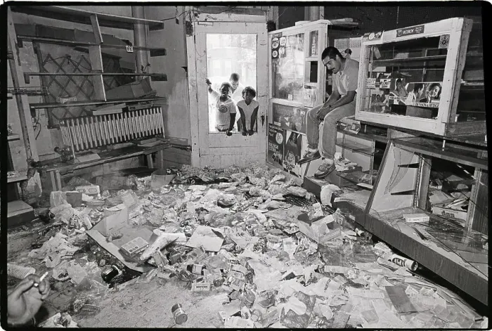 Framed Print : Man Seated in Trashed and Looted Store Framed Print : Man Seated in Trashed and Looted Store