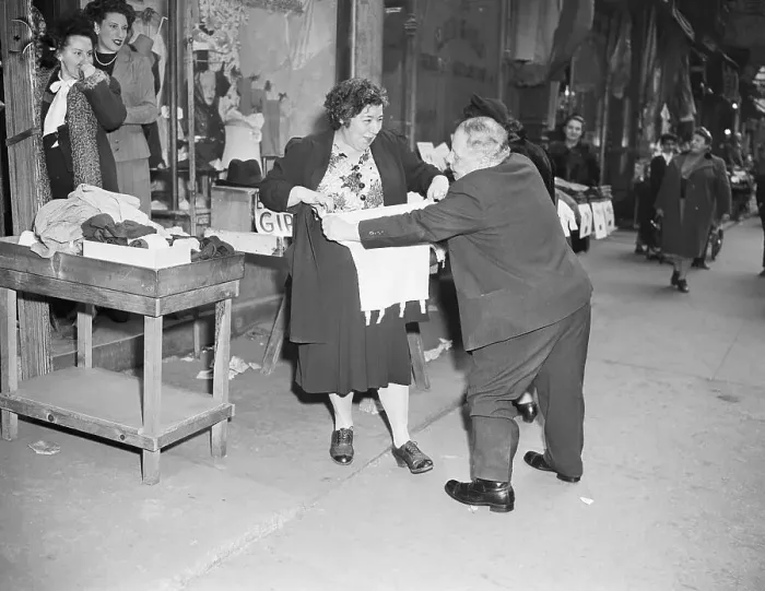 Framed Print : Man Selling Girdle to Woman on Sidewalk Framed Print : Man Selling Girdle to Woman on Sidewalk