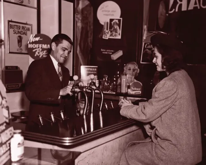 Framed Print : Man serving woman at soda fountain (B&W sepia tone)